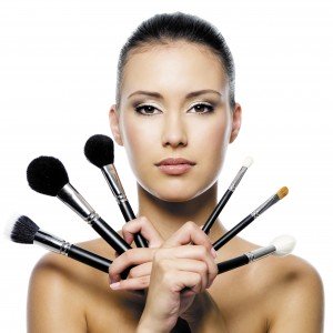 woman holding make up brushes